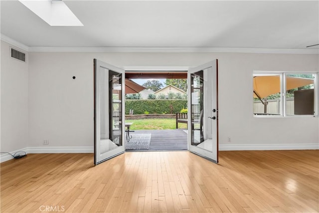 doorway featuring light hardwood / wood-style floors, french doors, a wealth of natural light, and a skylight