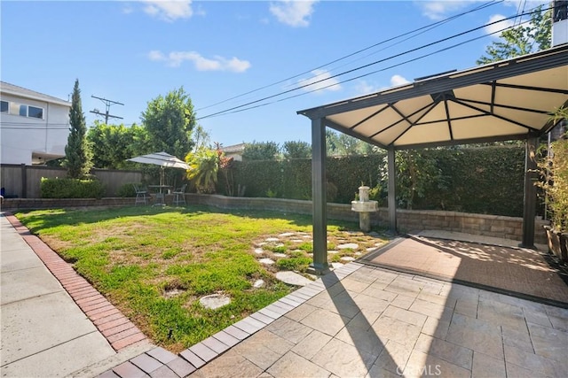 view of yard featuring a gazebo and a patio area