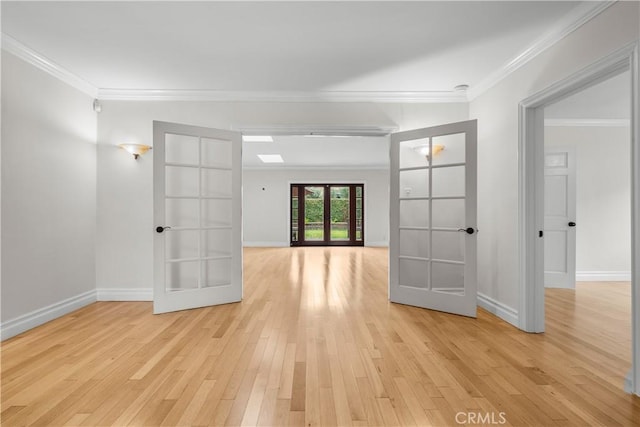 spare room featuring french doors, light hardwood / wood-style floors, and crown molding