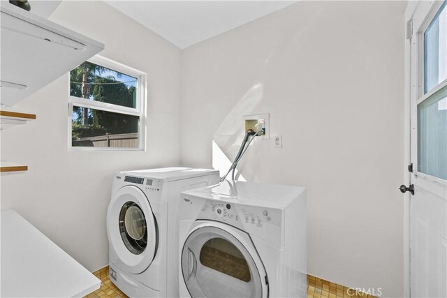 clothes washing area with washing machine and dryer