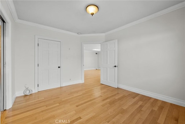 unfurnished bedroom with hardwood / wood-style flooring and ornamental molding