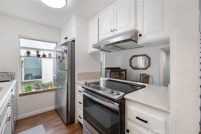 18411 Hatteras St Unit 120, Tarzana, CA 91356 - kitchen with appliances with stainless steel finishes, under cabinet range hood, dark wood finished floors, and light countertops