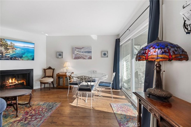 18411 Hatteras St Unit 120, Tarzana, CA 91356 - dining room with wood finished floors and a warm lit fireplace
