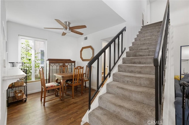 18411 Hatteras St Unit 120, Tarzana, CA 91356 - stairway featuring a ceiling fan, wood finished floors, and baseboards