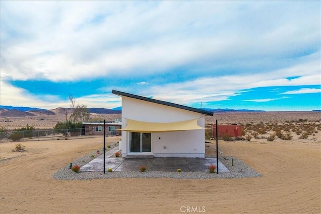 69444 Valle Vista Rd Unit 29, Palms, CA 92277 - back of house with a mountain view, a patio area, stucco siding, and view of desert landscape