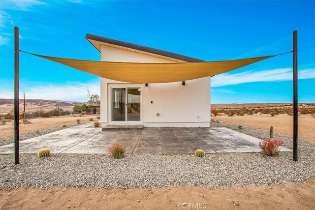 rear view of property featuring a patio area