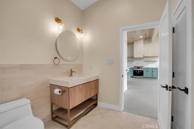 69444 Valle Vista Rd Unit 29, Palms, CA 92277 - bathroom with vanity, toilet, lofted ceiling, and tile walls