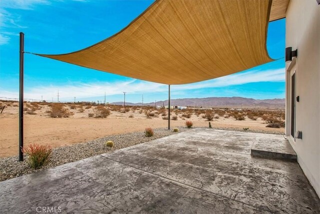 view of patio / terrace featuring a mountain view