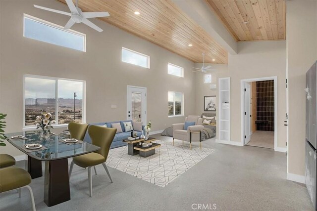 living room featuring wood ceiling, ceiling fan, and a towering ceiling