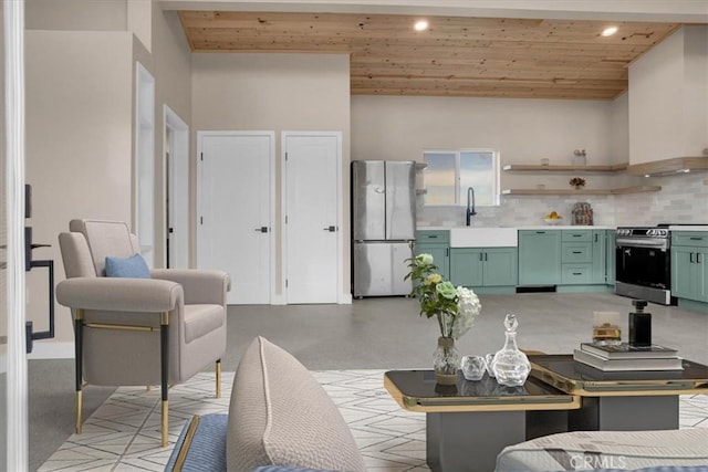 kitchen with sink, backsplash, green cabinetry, stainless steel appliances, and wooden ceiling