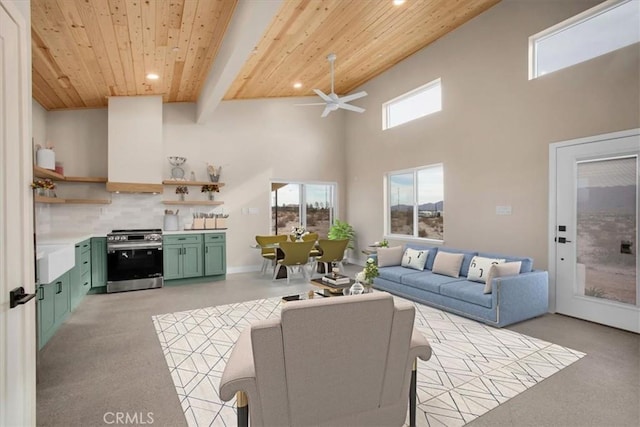 living room with beamed ceiling, a towering ceiling, ceiling fan, and wooden ceiling