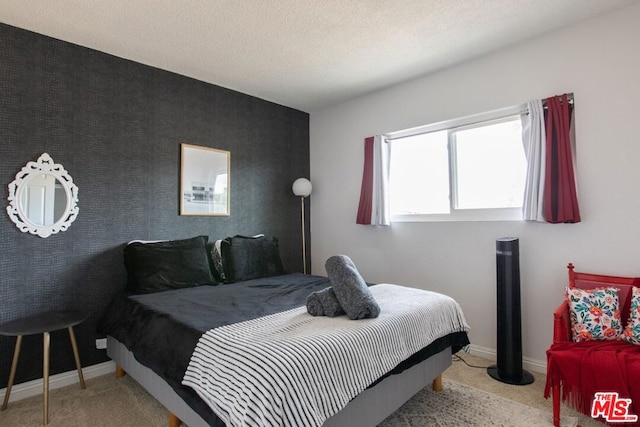 carpeted bedroom featuring a textured ceiling