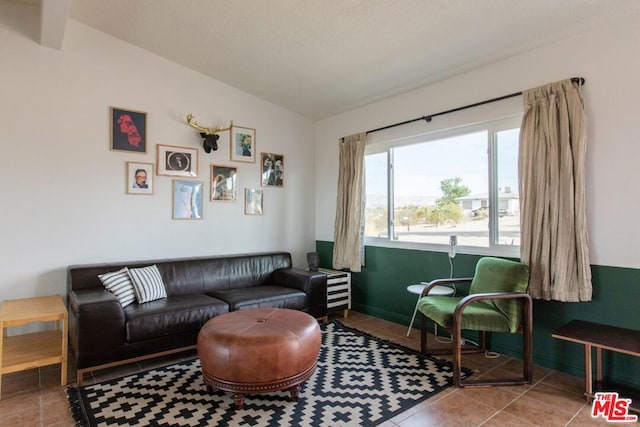 living room featuring tile patterned flooring and lofted ceiling