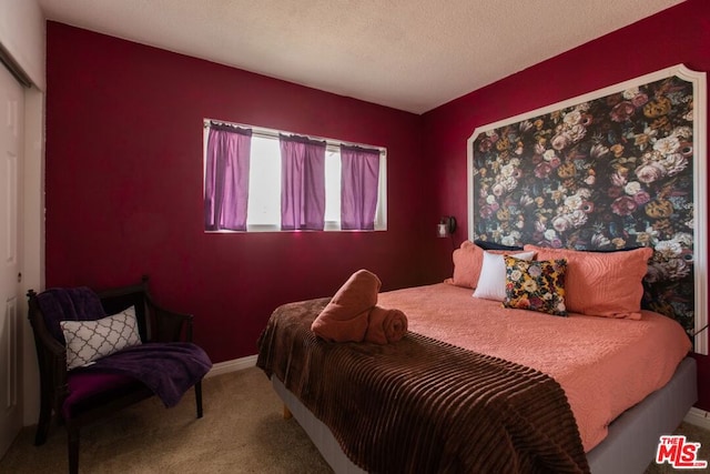 bedroom with carpet and a textured ceiling