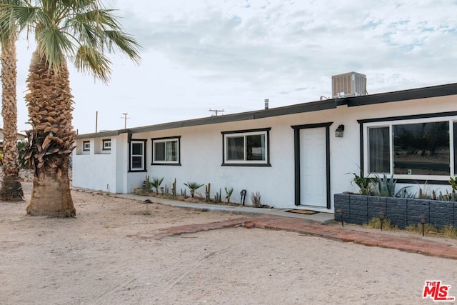 single story home featuring central air condition unit