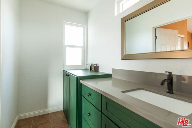 bathroom featuring tile patterned flooring and vanity