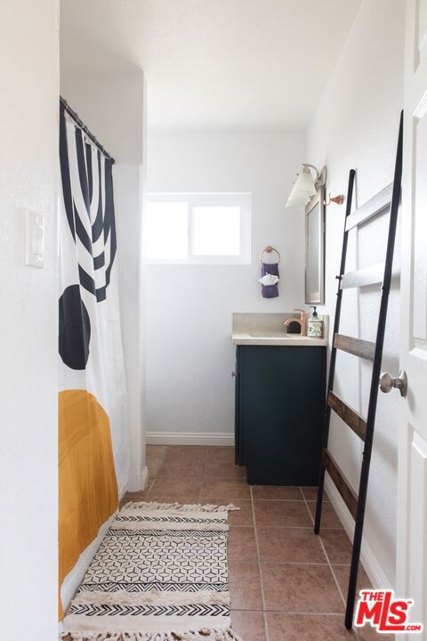 bathroom featuring tile patterned flooring and vanity