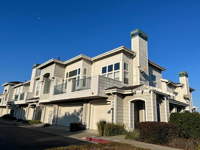 exterior space with a garage and a balcony