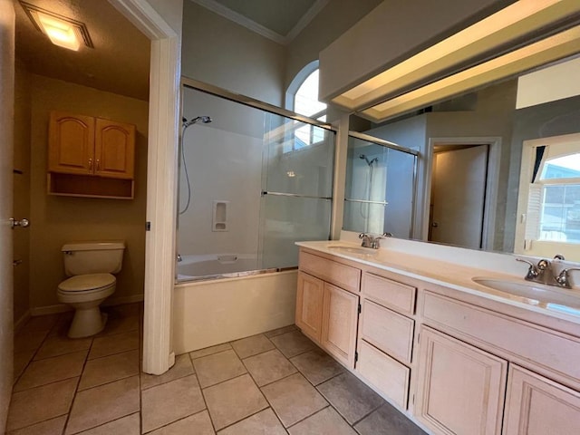 full bathroom featuring toilet, tile patterned flooring, vanity, and shower / bath combination with glass door