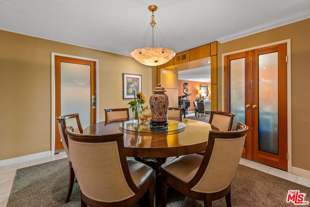 tiled dining area with ornamental molding and french doors