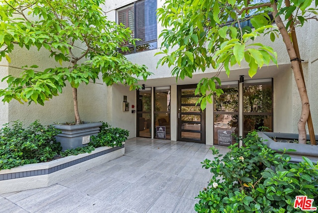 property entrance featuring a patio area