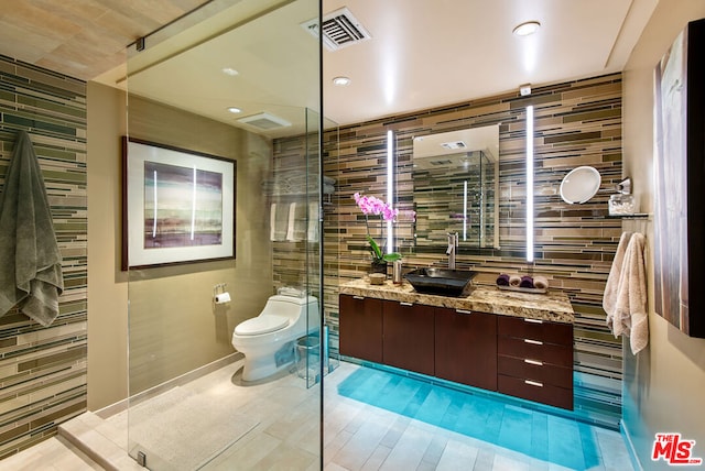 bathroom with vanity, toilet, and walk in shower