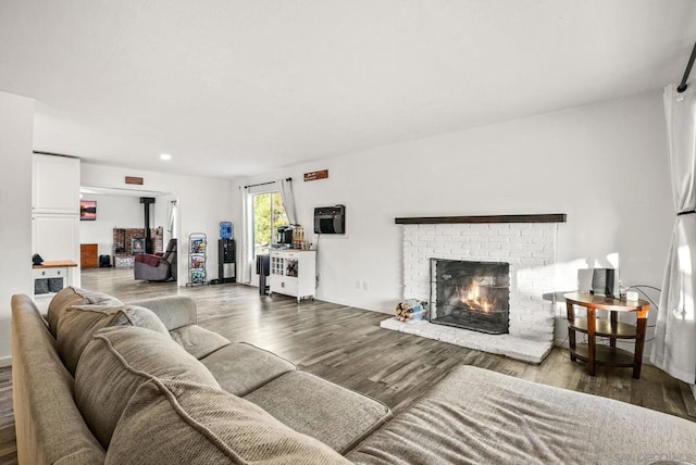 living room with wood-type flooring and a fireplace