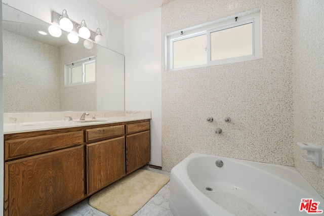 bathroom with a bathing tub and vanity