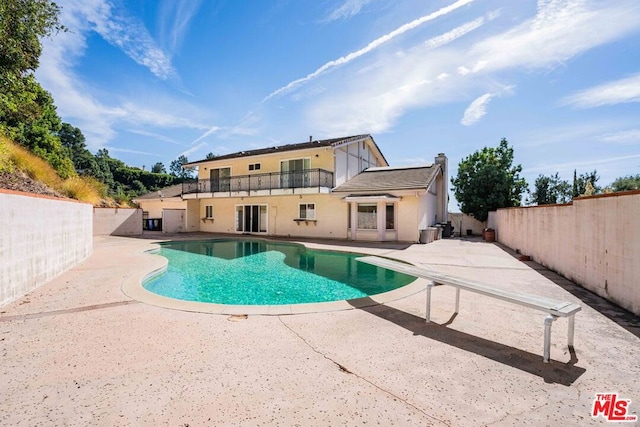 view of swimming pool with central AC unit and a patio