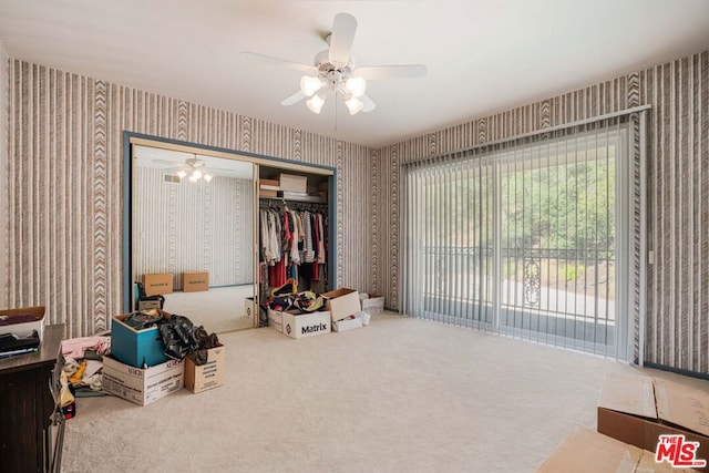 interior space with ceiling fan and carpet floors