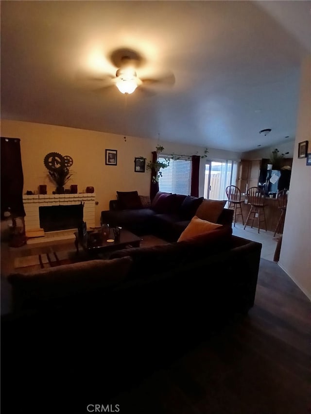 living room featuring ceiling fan and hardwood / wood-style flooring