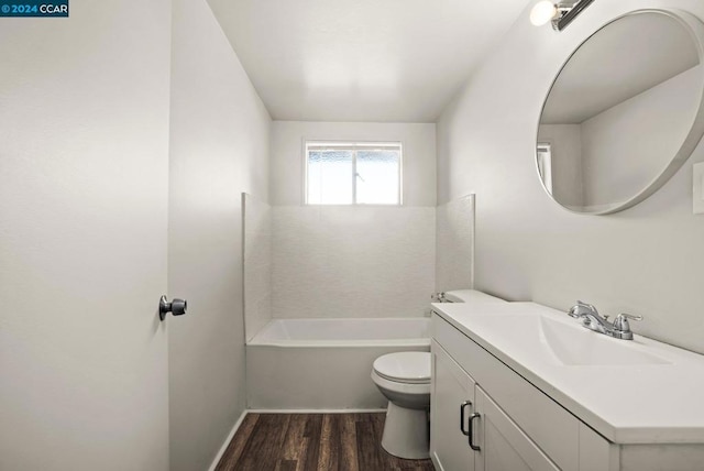 bathroom with vanity, toilet, and hardwood / wood-style floors