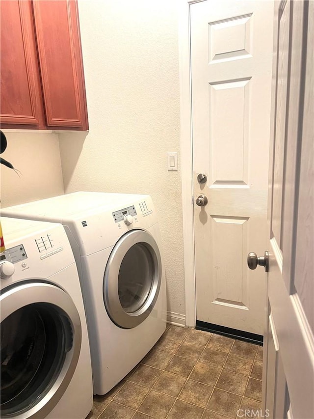 washroom with separate washer and dryer and cabinets