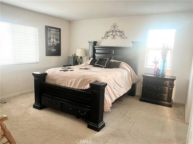 bedroom featuring light carpet