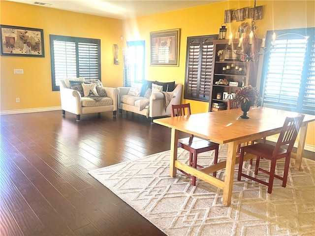 dining room with plenty of natural light, hardwood / wood-style floors, and a notable chandelier