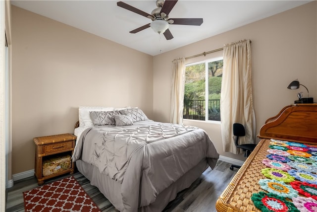 bedroom with ceiling fan and dark hardwood / wood-style floors