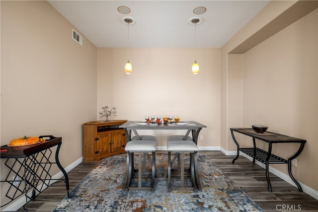 dining area with dark wood-type flooring