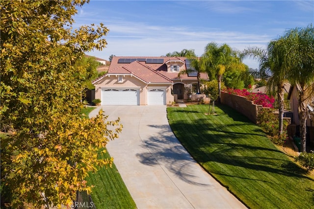 mediterranean / spanish home featuring a front yard