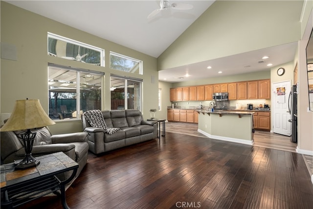 living room featuring high vaulted ceiling, dark wood-type flooring, and ceiling fan