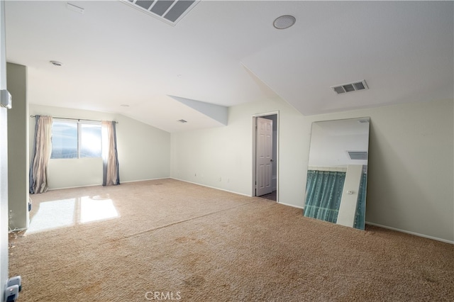 additional living space featuring carpet floors and vaulted ceiling