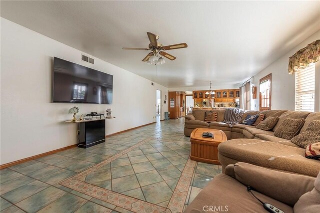 tiled living room with ceiling fan