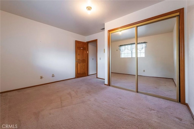 unfurnished bedroom featuring carpet floors and a closet