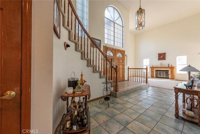 tiled entryway with a high ceiling