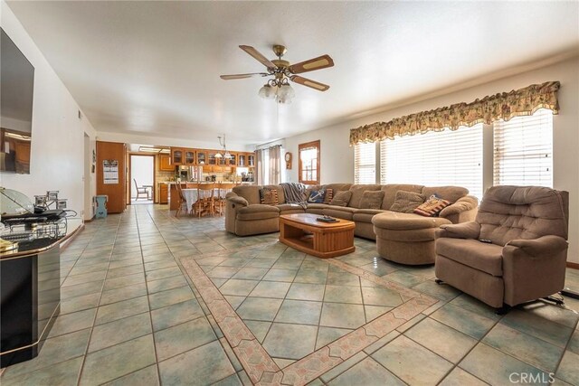 tiled living room with ceiling fan