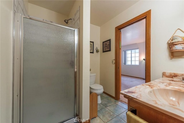 bathroom with toilet, tile patterned flooring, vanity, and walk in shower