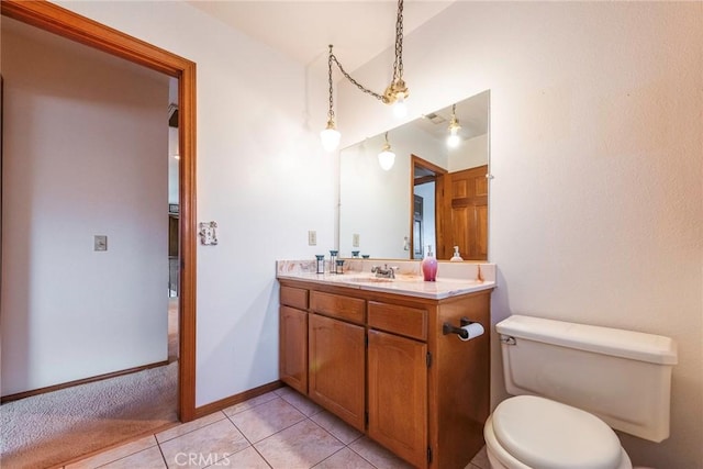 bathroom featuring tile patterned flooring, vanity, and toilet