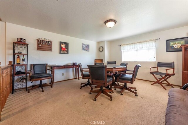 dining space featuring light carpet