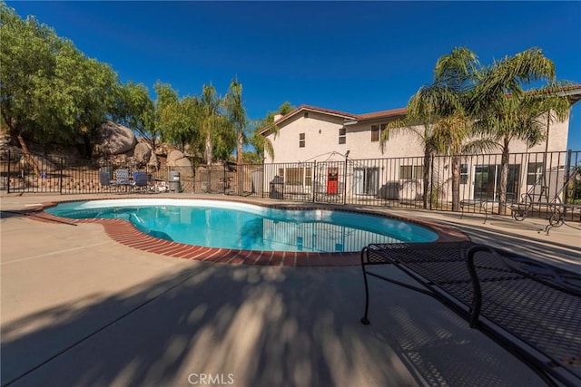 view of swimming pool with a patio