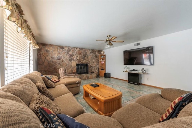 living room featuring ceiling fan, light tile patterned flooring, and a fireplace