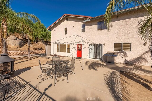 back of property with a patio